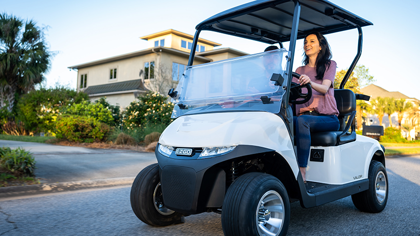 An E-Z-GO being driven down a street.