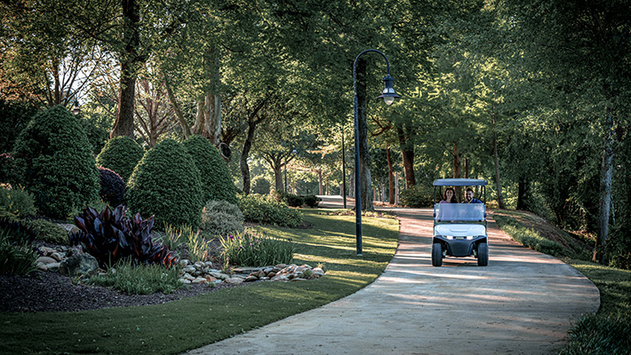 An E-Z-GO vehicle driving down a path