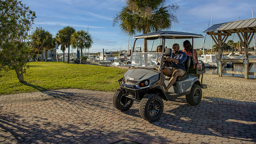 A family driving their E-Z-GO Express S4 down a cobbled path.