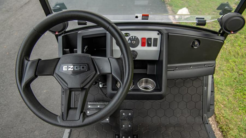 A close up look at the dash and steering column of an E-Z-GO Liberty vehicle.