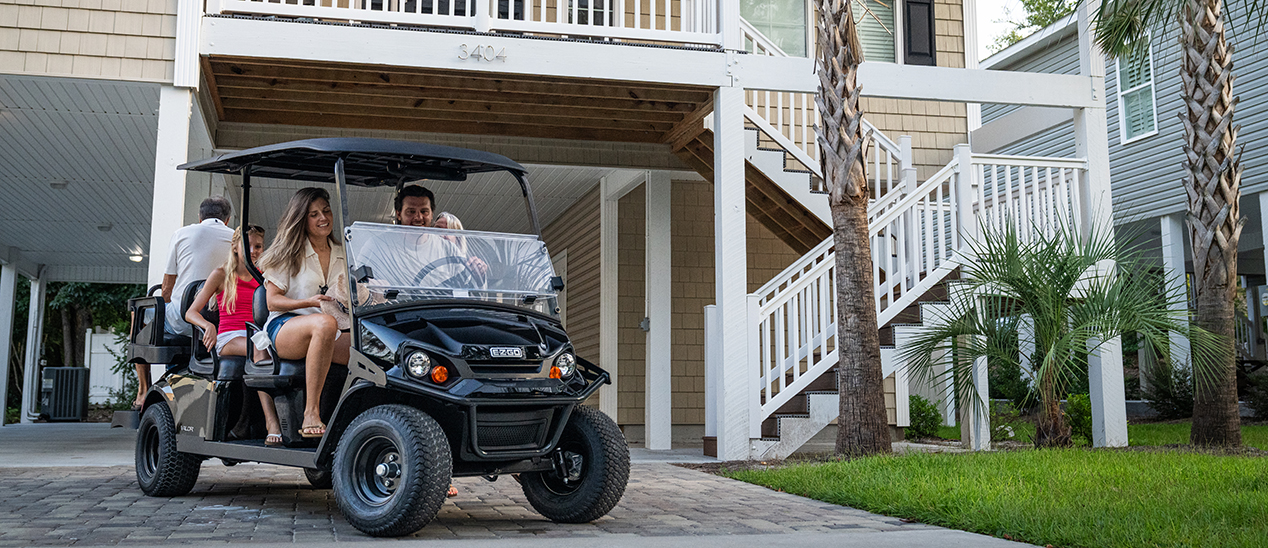 A family preparing to drive their E-Z-GO Valor 6 down the road.